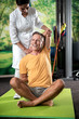 © Yakobchuk Olena - Smiling adult man is doing arm exercises