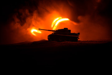 War Concept. Military silhouettes fighting scene on war fog sky background, Silhouette of armored vehicle below Cloudy Skyline At night. Attack scene. Tanks battle.