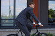 © ty - Handsome young businessman riding on his bicycle in the city. Ecologic transport concept.
