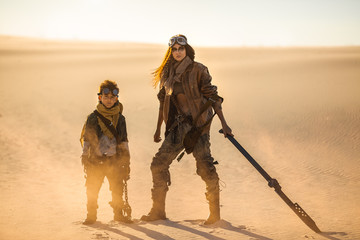 post apocalyptic woman and boy outdoors in a wasteland