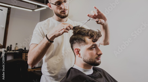 Young Man With Trendy Haircut At Barber Shop Barber Does The
