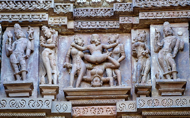 Erotic sculptures on the walls of famous Khajuraho Temples in India. Khajuraho Temples are one of the UNESCO World Heritage Sites in India. The temples are famous for their Nagara-style architectural 