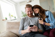 © NDABCREATIVITY - Young couple at home websurfing on internet