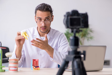 Young male doctor dentist recording video for his blog