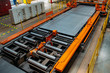Steel sheet moving on roller conveyor in metalworking workshop