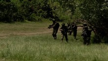 A Group Of Masked Military Soldiers Moving Through The Forest, The Operation To Release The Hostages, The Unit Is Put Forward In The Given Coordinates