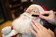 © Nexa - Santa Claus shaving in barbershop. Looking in the mirror. Getting ready for Christmas. Beautifying for the holidays. Bearded. Cuting.