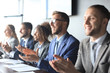 © ty - Photo of happy business people applauding at conference.