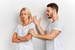 © alfa27 - Young couple having an argument, frustrated angry man scolding his wife. close eup portrait, conflict, isolated white background. studio shot. divorce