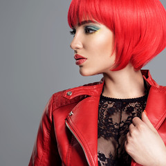 Wall Mural - Beautiful sexy woman with bright red bob hairstyle. Fashion  model. Sensual  gorgeous girl in a leather jacket. Stunning face of a pretty lady.