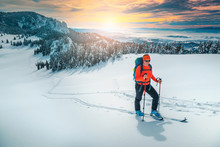 Ski touring on the snowy hills at sunset, Carpathians, Romania