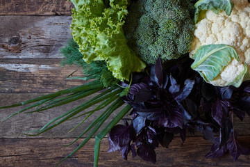 Wall Mural - Fresh vegetables and herbs on an old rough wooden surface, healthy eating concept, selective focus