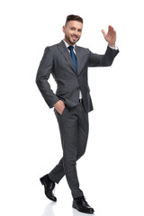 Wall Mural - happy young businessman is walking and waving his hand