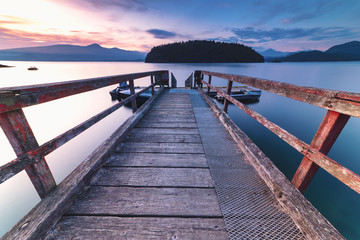 Wall Mural - Brilliant sunset rocky beach scenes at sunset with mountains, sky and clouds lit up in early autumn.  Pacific North West Bowen Island British Columbia Canada close to Vancouver.