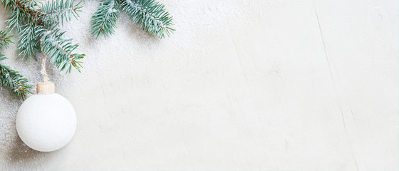 White snow Christmas banner with Christmas tree branch and ball