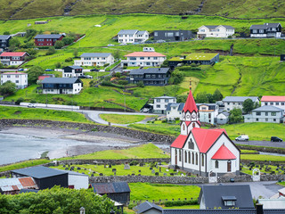 Wall Mural - view to little city and red church on the coast on Faroe islands Big size