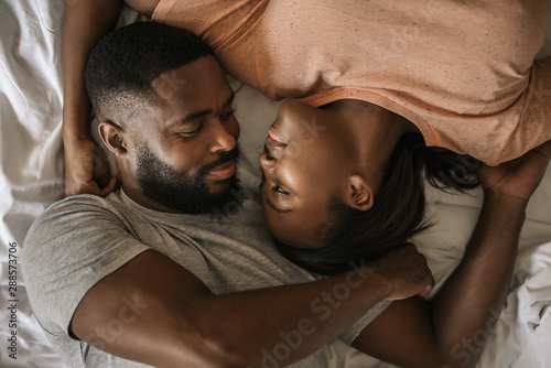 Fotografía Loving African American couple looking at each other in bed