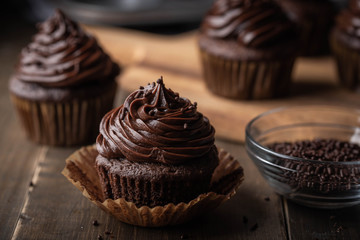 Sticker - chocolate cupcake on dark wooden background