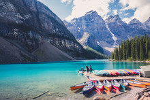 Colorful Canoes In Blue Turquoise Waters In Moraine Lake, Banff National Park, Alberta, Canada