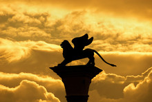 Saint Mark Winged Lion, Symbol Of The Old Venice Republic, Old Medieval Statue Among Golden Clouds