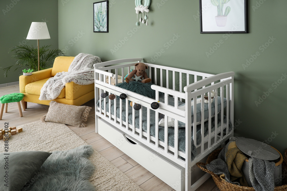 Interior of modern baby room with crib