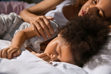 Sticker - Little African-American girl with mother sleeping in bed at night