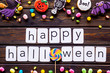 © 9dreamstudio - Frame from halloween figures around happy halloween copy on wooden background top view