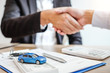 © joyfotoliakid - Sale agent handshake deal to agreement successful car loan contract with customer and sign agreement contract  Insurance car concept.