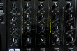 © Gayan - Wide angle photo of black sound mixer controller with knobs and sliders