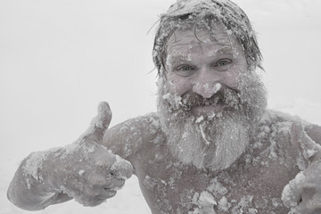 Bearded man, after bathing in the snow