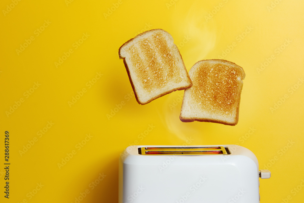 Slices of toast jumping out of the toaster - obrazy, fototapety, plakaty 