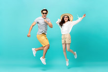 Energetic Asian Couple In Summer Beach Casual Clothes Jumping