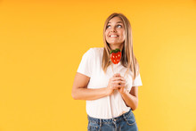 Image Closeup Of Joyous Blond Woman Wearing Casual T-shirt Looking Upward At Copyspace While Holding Paper Strawberry