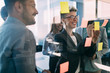 © NDABCREATIVITY - Group of coworkers working together on business project in modern office