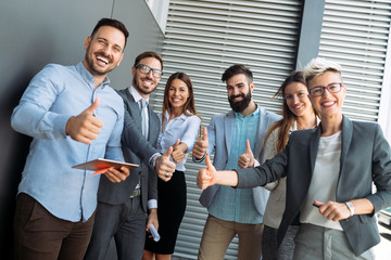 Business team celebrating a triumph with arms up