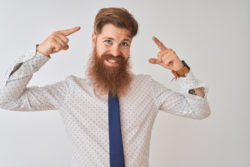 Sticker - Young redhead irish businessman standing over isolated white background smiling pointing to head with both hands finger, great idea or thought, good memory