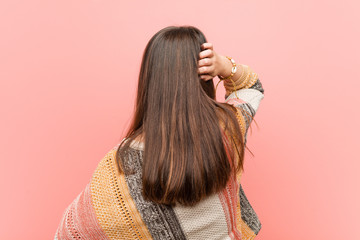 Wall Mural - Little hippie girl from behind thinking about something.