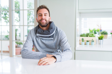 Wall Mural - Handsome man wearing casual sweatshirt at home and smiling positive