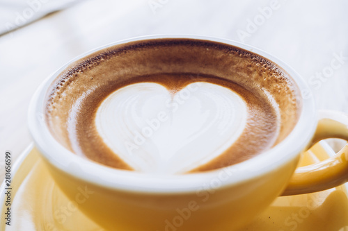 Close Up Hot Cappuccino Coffee Cup On Wooden Tray With Heart Latte