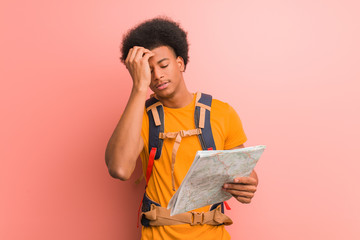 Wall Mural - Young african american explorer man holding a map worried and overwhelmed