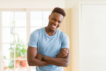 Sticker - Handsome african young man smiling cheerful with crossed arms