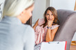 © Graphicroyalty - Woman at therapy session. Attentive psychologist. Young woman at psychotherapy thinking about advice she received