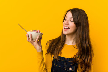 little caucasian girl holding a cereal bowl