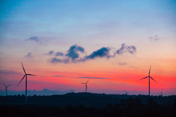 Wall Mural - silhouette of wind turbine located on a ridge with wind blowing all the time. Making it able to effectively produce renewable electricity, which is another clean energy.