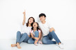 © Tom Wang - happy young family sitting on floor and looking up