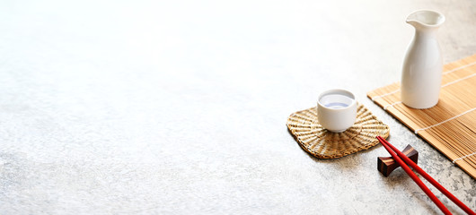 Red chopsticks and japanese sake oriental drink style on the table,copy space