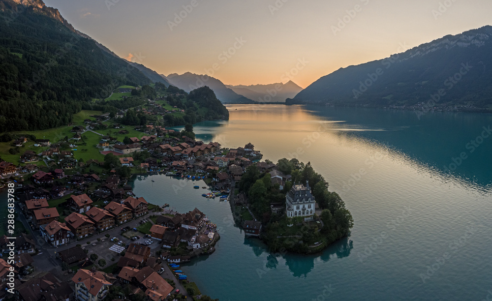 Overhead drone aerial view of The beautiful lake Brienz and village of ...