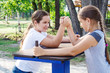© Radnatt - two teenage girls are engaged in arm wrestling
