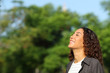 © Antonioguillem - Happy mixed race woman breathing fresh air