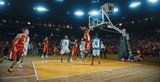 Fototapeta Sport - Basketball players on big professional arena during the game. Tense moment of the game. Celebration
